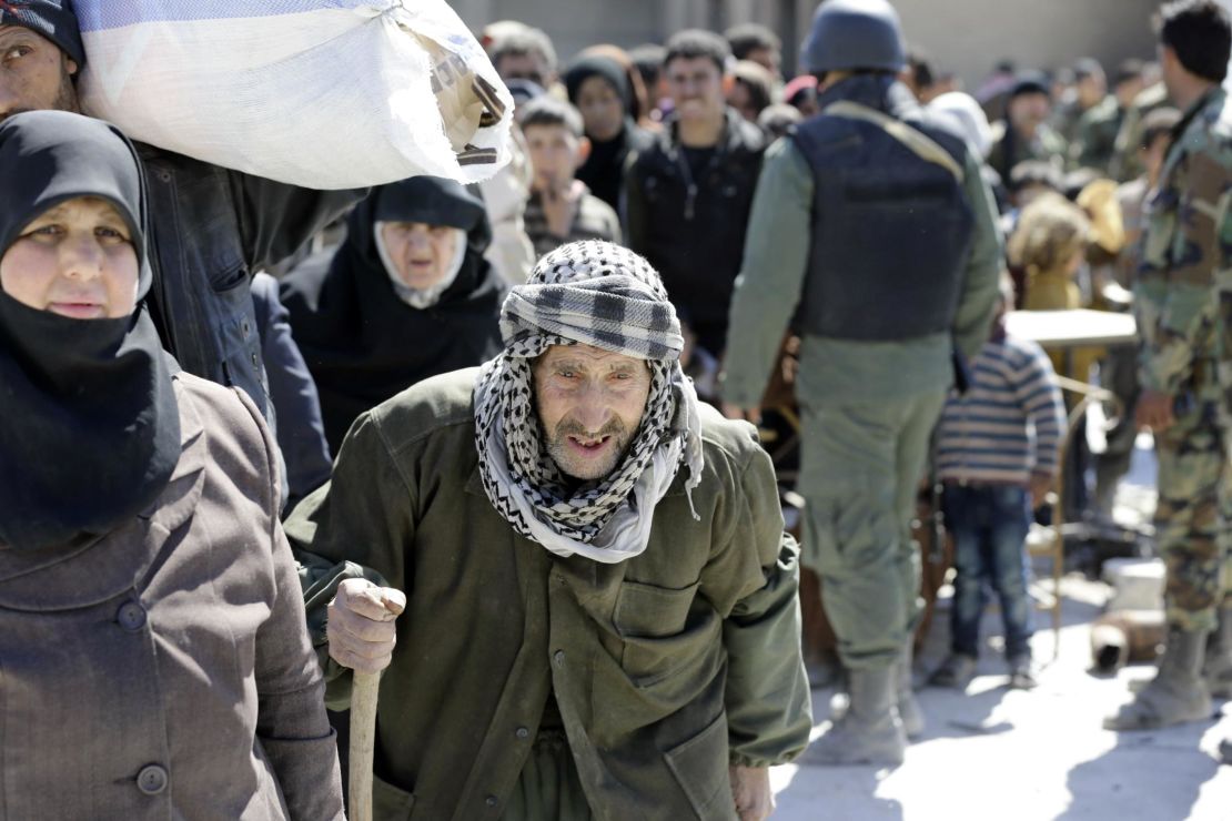 Syrian civilians evacuated from Eastern Ghouta wait to be relocated to other areas. 
