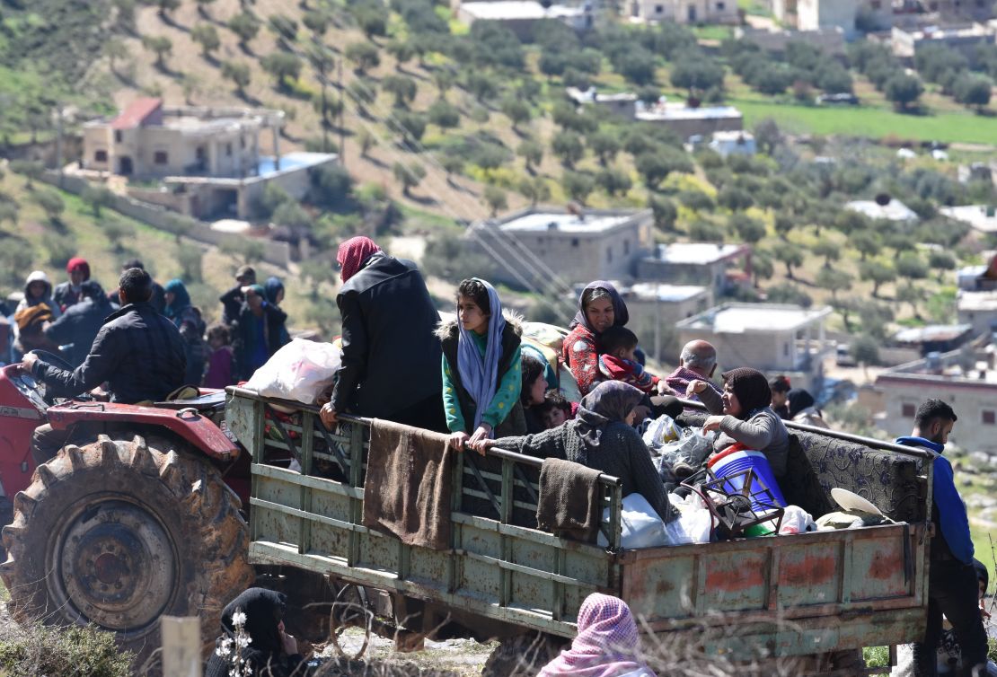 Civilians flee the city of Afrin in northern Syria on March 16, 2018. 