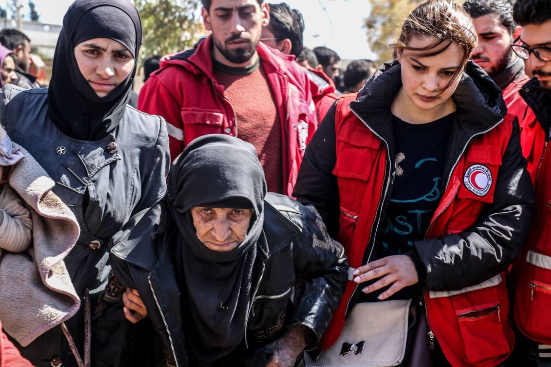 Syrian Arab Red Crescent workers help a woman this week in Eastern Ghouta.