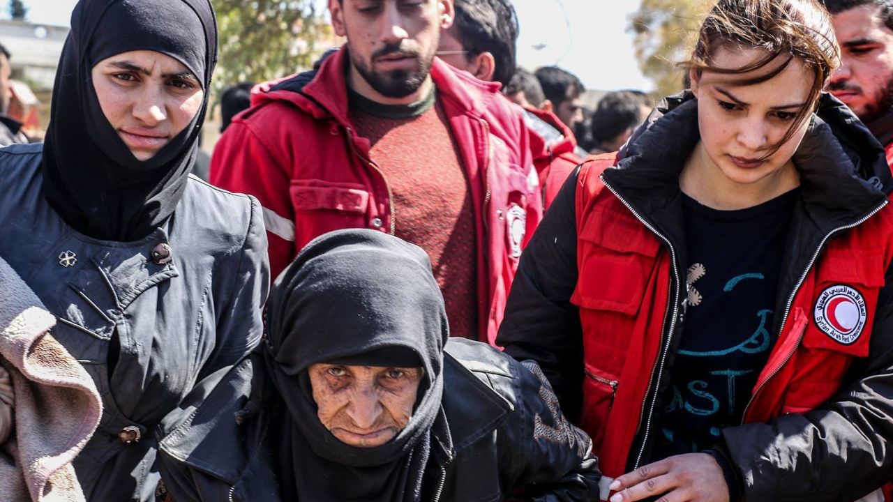 Syrian Arab Red Crescent workers help a woman this week in Eastern Ghouta.