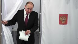 Russian President and Presidential candidate Vladimir Putin exits a polling booth as he prepares to cast his ballot during Russia's presidential election in Moscow, Russia, Sunday, March 18, 2018. Putin's victory in Russia's presidential election Sunday isn't in doubt. The only real question is whether voters will turn out in big enough numbers to hand him a convincing mandate for his fourth term — and many Russian workers are facing intense pressure to do so. (Yuri Kadobnov/Pool Photo via AP)