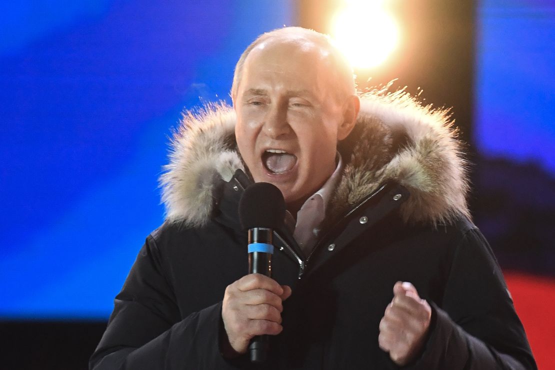 Putin addresses the crowd during Sunday night's rally and concert in Moscow.