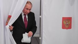Presidential candidate, President Vladimir Putin walks out of a voting booth at a polling station during Russia's presidential election in Moscow on March 18, 2018. / AFP PHOTO / POOL / Yuri KADOBNOV        (Photo credit should read YURI KADOBNOV/AFP/Getty Images)