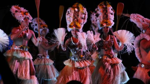 Dancers from Aulani's KA WA'A luau perform a 'ōte'a, a traditional dance of Tahiti.