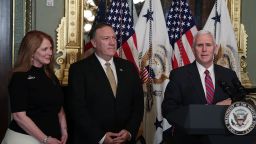 U.S. Vice President Mike Pence (R) speaks as Mike Pompeo (2nd L) and wife Susan Pompeo (L) look on during a swearing in ceremony for Pompeo to become CIA Director in January 2017