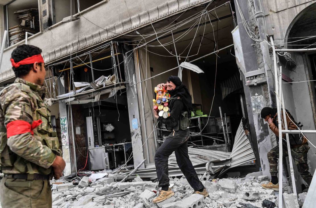 Rebels loot shops in Afrin.