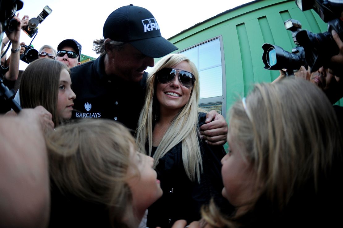 Mickelson embraces wife Amy and shares his 2010 Masters win with his three kids.