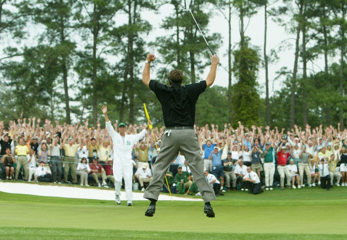 Mickelson reaches for the sky after winning his first major at the 2004 Masters.