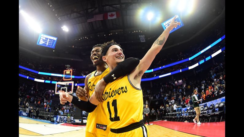 K.J. Maura points to the crowd as he and teammate Jourdan Grant celebrate UMBC's <a href="http://bleacherreport.com/articles/2765003-umbc-shocks-virginia-in-1st-1-vs-16-seed-upset-in-ncaa-tournament-history" target="_blank" target="_blank">shocking upset of Virginia</a> on Friday, March 16. It was the first time in history that a No. 16 seed defeated a No. 1 seed at the NCAA Tournament, and UMBC — which stands for the University of Maryland, Baltimore County — did it in style. The Retrievers blew out Virginia 74-54. No. 1 seeds had been 135-0 going back to 1985.