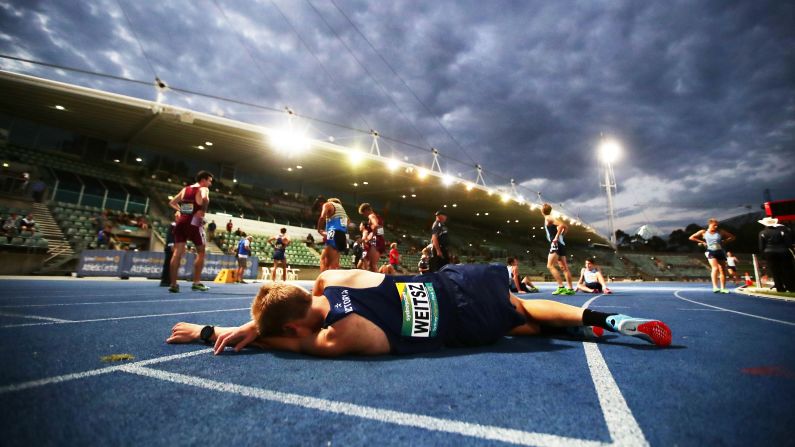 Robert Weitsz rests on a track in Sydney after running the 2,000-meter steeplechase at the Australian Junior Championships on Wednesday, March 14.