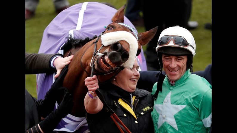 Jockey Davy Russell celebrates after he rode Presenting Percy to victory at the Cheltenham Festival in England on Wednesday, March 14.