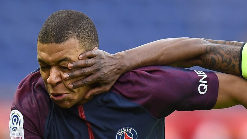 Kylian Mbappe, a forward for Paris Saint-Germain, is hit in the face by Abdoulaye Bamba during a French league match in Paris on Wednesday, March 14. Mbappe scored both goals in PSG's 2-1 victory over Angers.