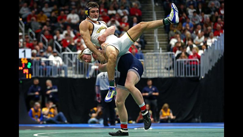 Penn State wrestler Bo Nickal, bottom, competes against Michigan's Domenic Abounader during the NCAA Championships on Friday, March 16. Nickal went on to win his second straight title in his weight class, and Penn State won its seventh national title in eight years.