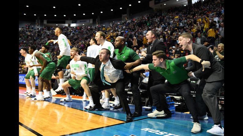 People react on Marshall's bench during the school's first-round NCAA Tournament game on Friday, March 16. The Thundering Herd, a 13 seed, upset fourth-seeded Wichita State 81-75. It was Marshall's first-ever win in the NCAA Tournament.
