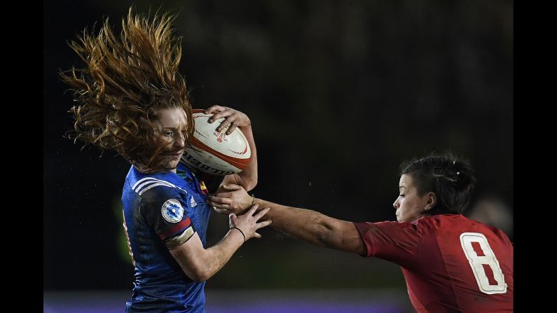 France's Pauline Bourdon evades a tackle by Wales' Sioned Harries during a Six Nations rugby match in Colwyn Bay, Wales, on Friday, March 16. France won 38-3 to clinch its second title in three years.