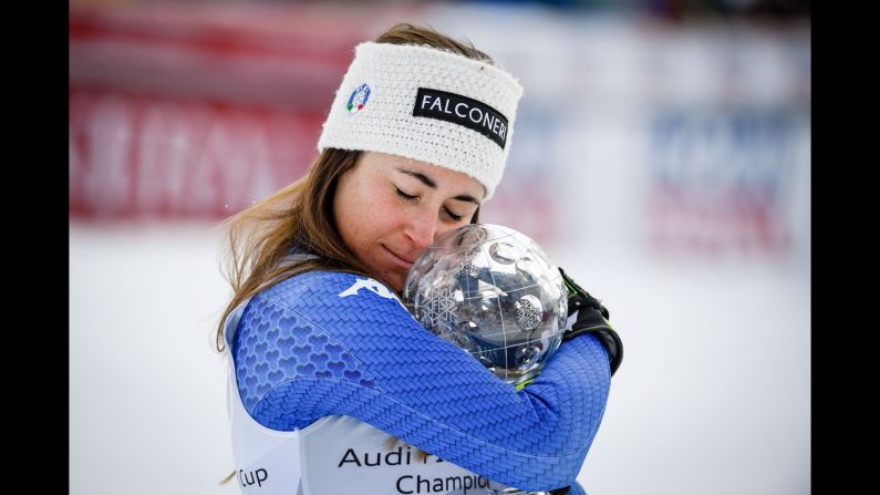 Italian skier Sofia Goggia embraces the World Cup trophy she received for the downhill title on Wednesday, March 14. Goggia also won Olympic gold in the downhill last month.