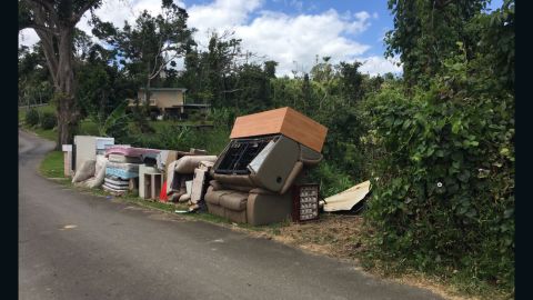 Trash awaiting pickup on the side of the road shows residents are still cleaning out.