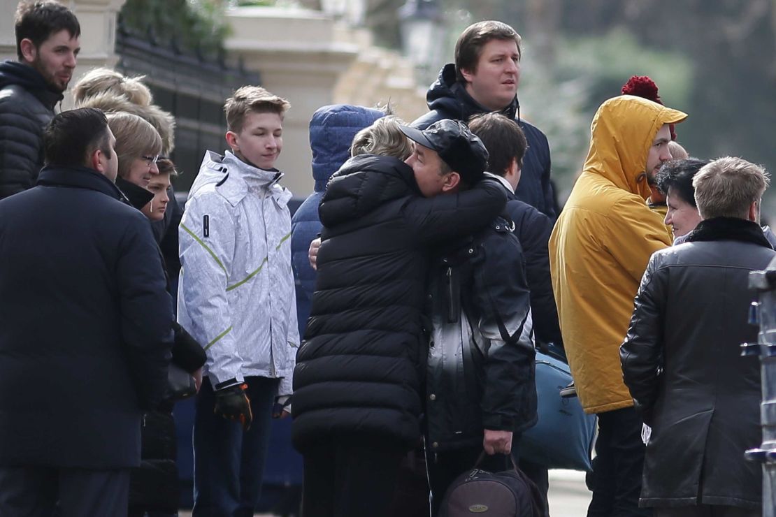 People say goodbye outside the Russian Embassy in London on Tuesday.