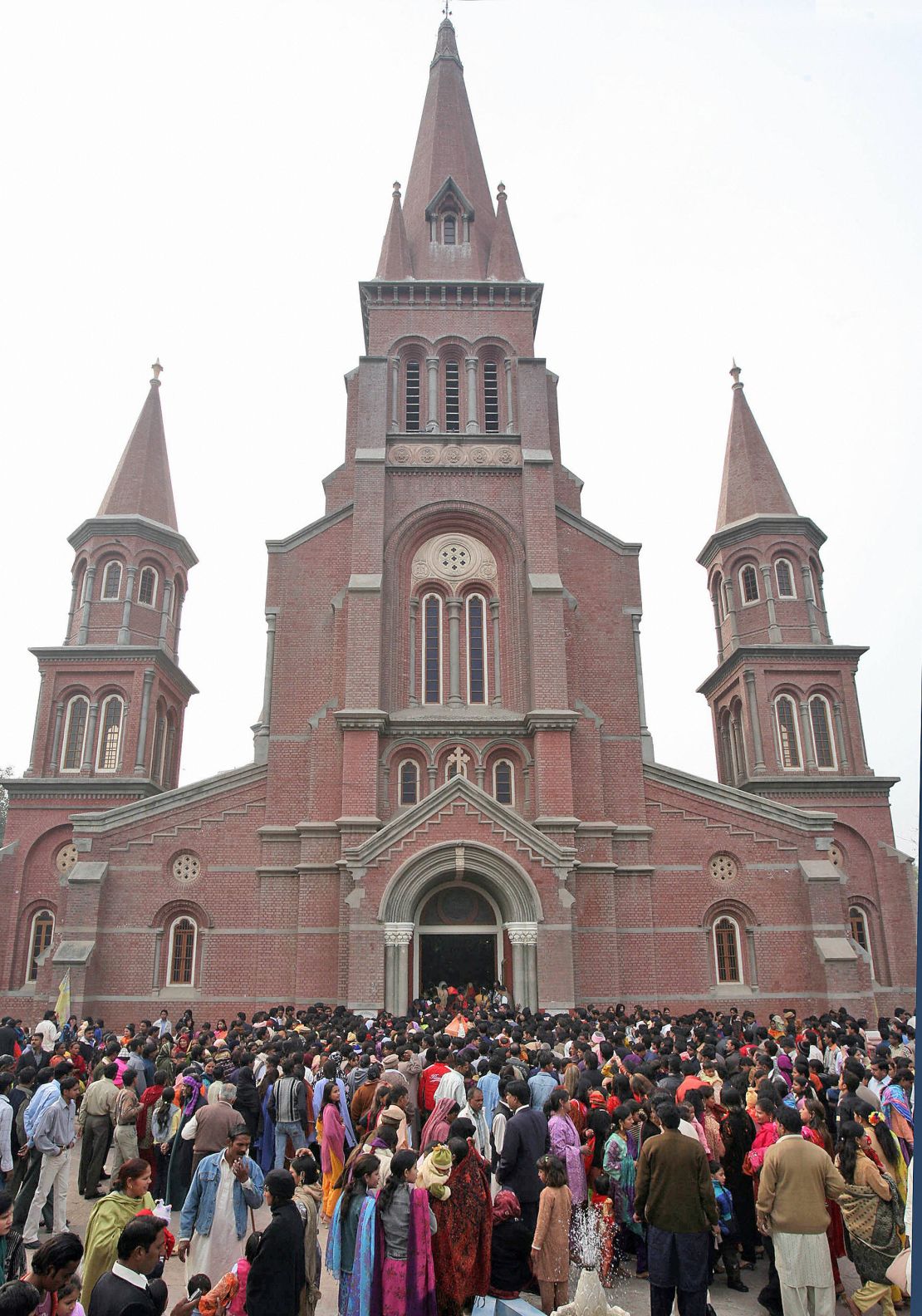Pakistani Christians gather after attending a Christmas mass outside the Sacred Heart Cathedral Church in Lahore.