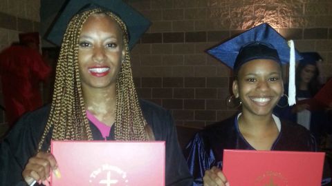 Amy Deanna, left, poses with a friend at her high school graduation.