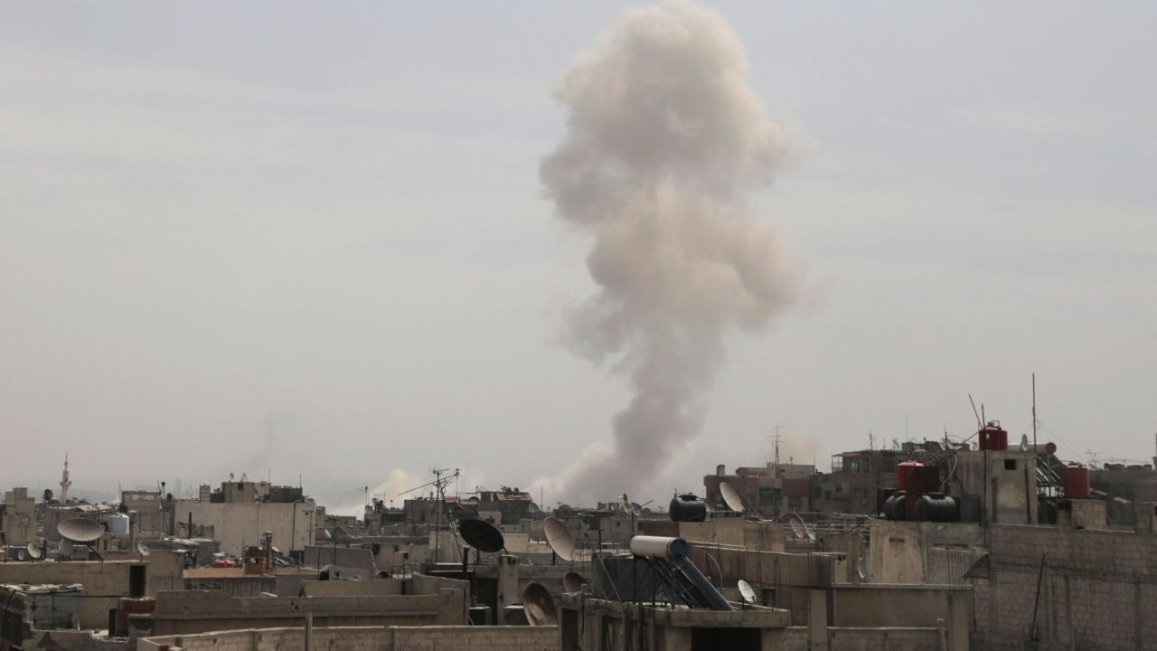 Smoke billows following Syrian government air strikes on the Eastern Ghouta rebel-held enclave of Douma, on the outskirts of the capital Damascus on March 20, 2018.
Syrian regime and allied forces battled to suppress the last pockets of resistance in and around Damascus while the beleaguered Kurds in the north braced for further Turkish advances. Assad has in recent months brought swathes of territory back under his control thanks to heavy Russian involvement, as well as support from other forces such as the Iran-backed Lebanese Hezbollah militia. Eastern Ghouta's main town of Douma remains under rebel control but even as a trickle of emergency medical evacuations was scheduled to continue, the regime continued to pound the enclave. / AFP PHOTO / HAMZA AL-AJWEH        (Photo credit should read HAMZA AL-AJWEH/AFP/Getty Images)