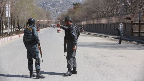 Police patrol the streets after a blast in front of Kabul University on Wednesday.