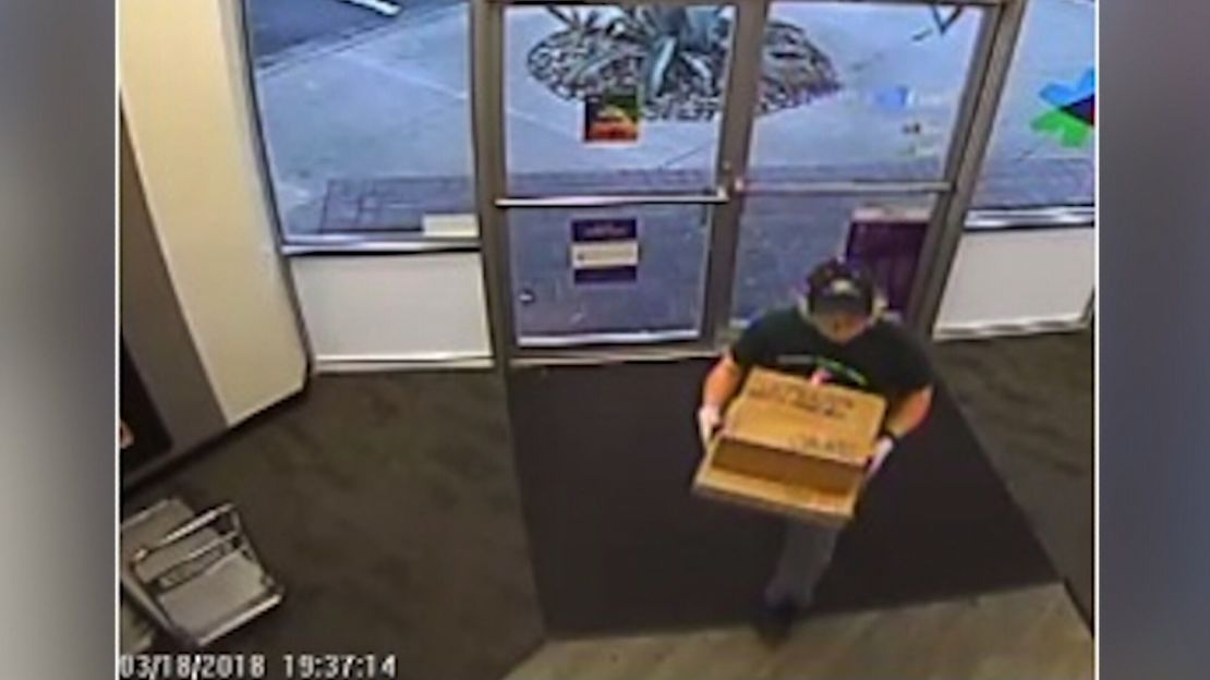 The person police believe to be Conditt takes two packages to the FedEx store.