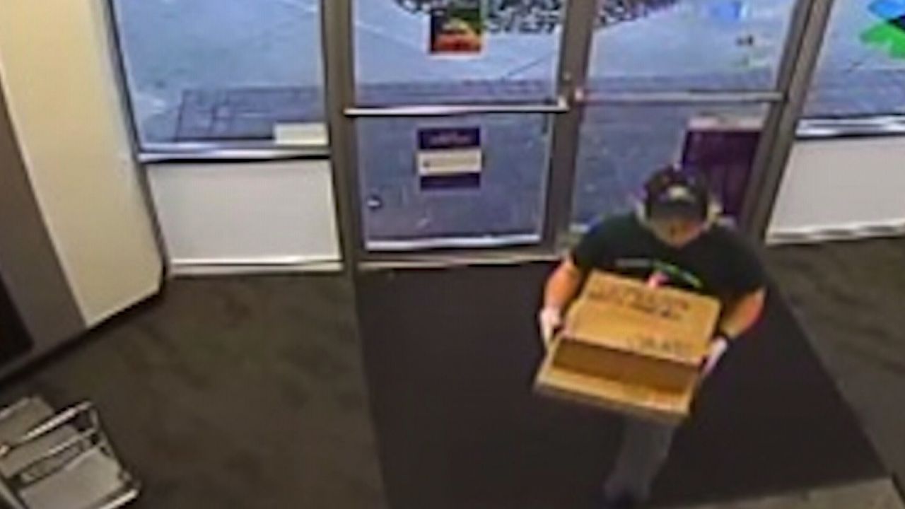 The person police believe to be Conditt takes two packages to the FedEx store.