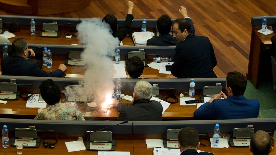 Opposition lawmakers ignite a tear gas canister, disrupting a parliamentary session in Pristina on Wednesday.