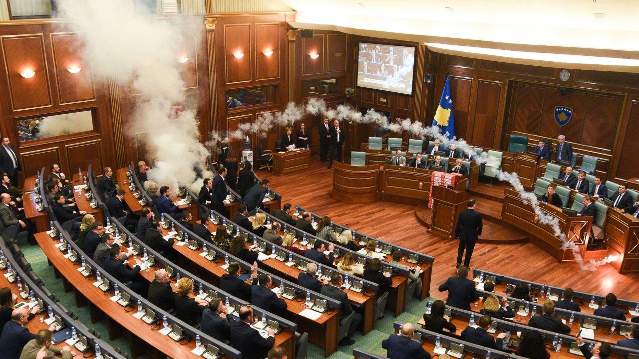 TOPSHOT - Kosovo's opposition lawmakers release a teargas canister inside the country's parliament in Pristina on March 21, 2018 before a vote for an agreement to ratify or not a border demarcation deal signed in 2015 with Montenegro. / AFP PHOTO / Armend NIMANI        (Photo credit should read ARMEND NIMANI/AFP/Getty Images)