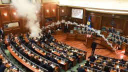 Kosovo's opposition lawmakers release a teargas canister inside the country's parliament in Pristina on Wednesday.