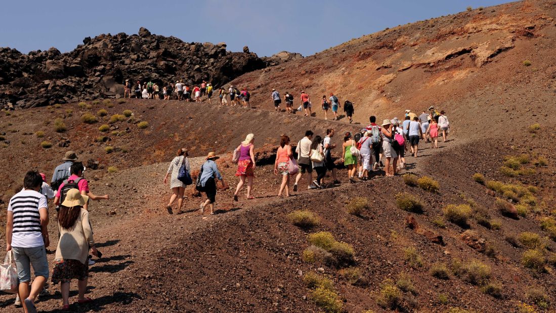 <strong>Santorini volcano walk: </strong>Crescent-shaped Santorini faces a submerged crater on the west side, while on the east it has boundless stretches of black sand. Visitors can hike the two slopes and see the still active volcanic islands inside the crater.