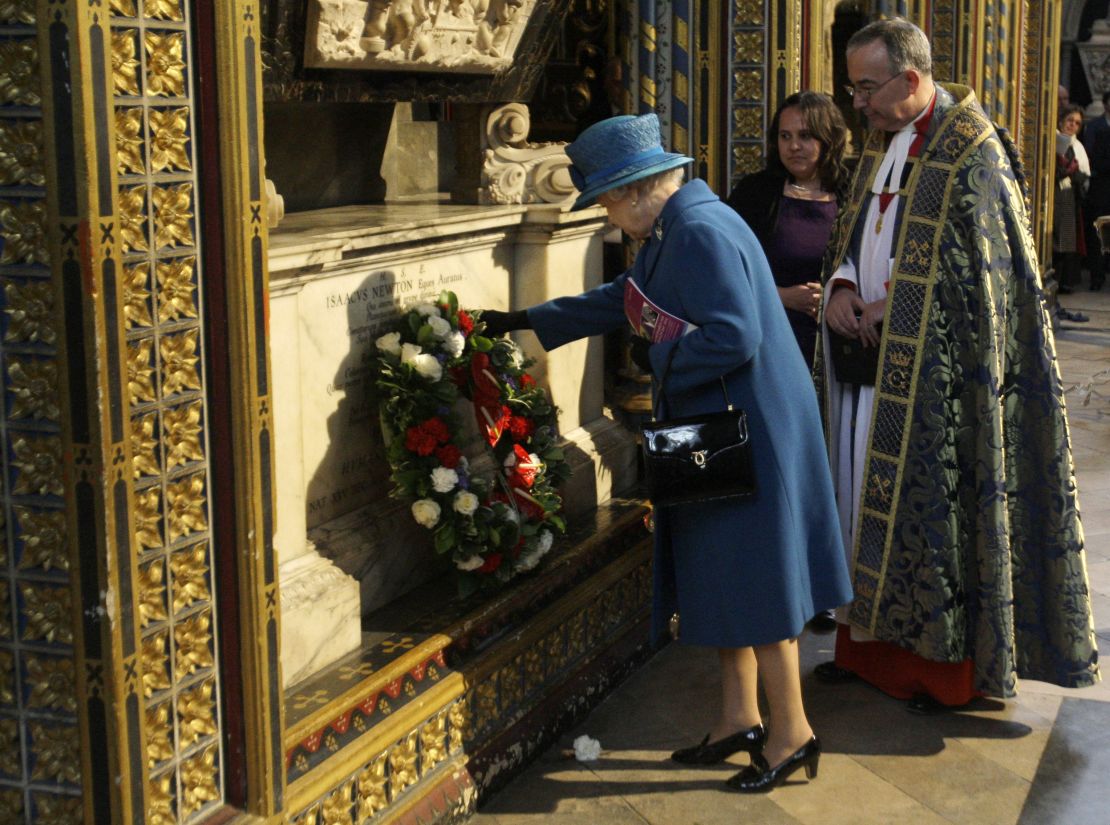 Queen Elizabeth II lays a wreath on the tomb of Sir Isaac Newton in London, on March 8, 2010.