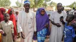 A girl released by Boko Haram walks with her father (L) in Dapchi on March 21, 2018. 
Boko Haram Islamists who kidnapped 110 schoolgirls in Dapchi, northeast Nigeria, just over a month ago have so far returned 101 of the students to the town, the government said today. / AFP PHOTO / -        (Photo credit should read -/AFP/Getty Images)