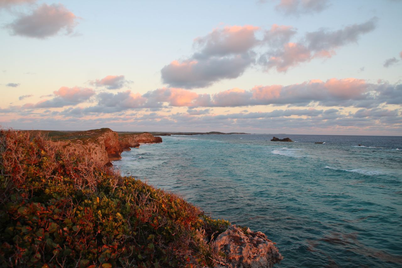 <strong>Middle Caicos: </strong>Spectacular views in both directions greet sightseers at the top of cliffs rising above Mudjin Harbor. There's also a stone path leading to a staircase that descends through a sea cave to the beach below.