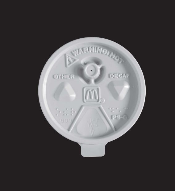A McDonald's coffee lid featuring Braille markings and a prominent safety warning.