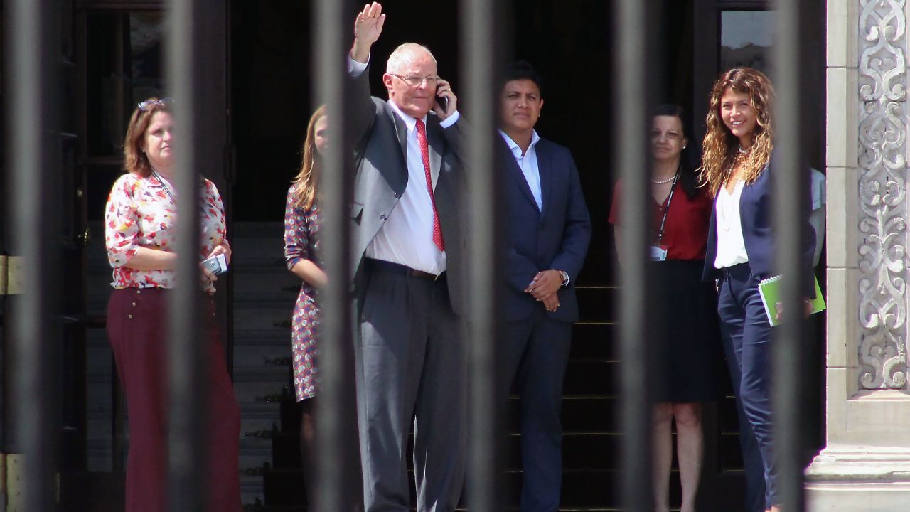 Former President Pedro Pablo Kuczynski  waves as he leaves the Palace of Government in Lima after recording a televised message announcing his resignation. 