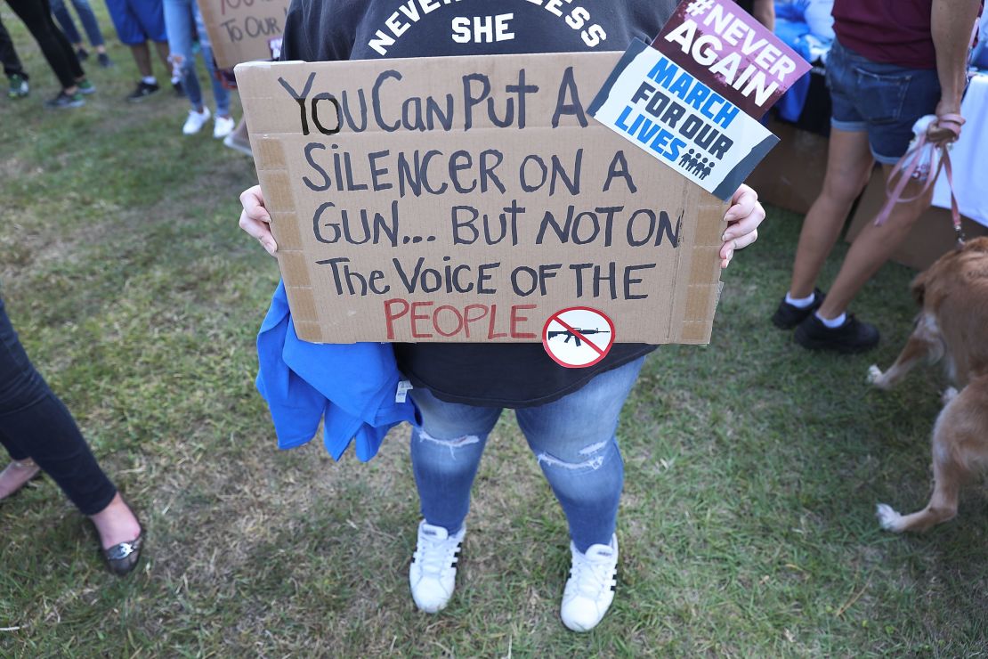 Sophie Phillips holds a sign at a Florida rally for those heading to March for Our Lives in Washington.