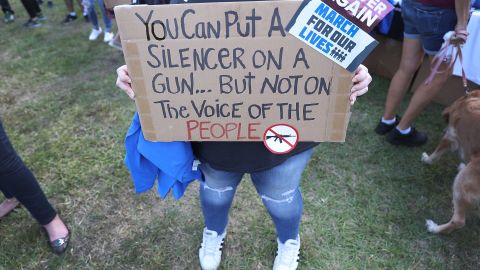 Sophie Phillips holds a sign at a Florida rally for those heading to March for Our Lives in Washington.