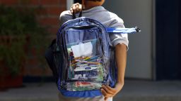 A secondary school student walks carrying a new transparent backpack in Guadalajara, Mexico on October 25, 2012. The transparent backpacks are part of the program "Escuela Segura" (Safe School ) to avoid violence in schools.