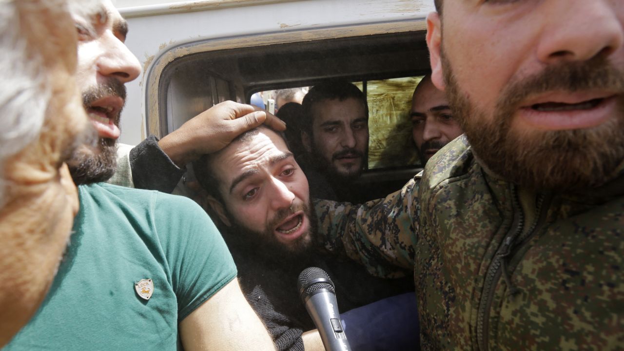 A vehicle carries civilians and soldiers whom the regime says were kidnapped by rebels and liberated.