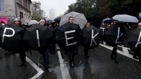 Women march holding umbrellas, a symbol of their protest against proposed abortion restrictions, in Warsaw in October 2017. 
