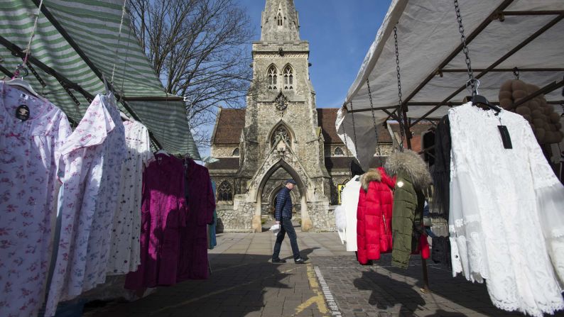 A man passes by market stalls in Romford.