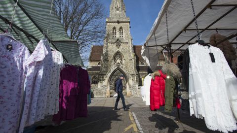 A man passes by market stalls in Romford. 
