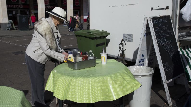 A customer uses condiments outside Crosbie's The Better Plaice seafood stall.