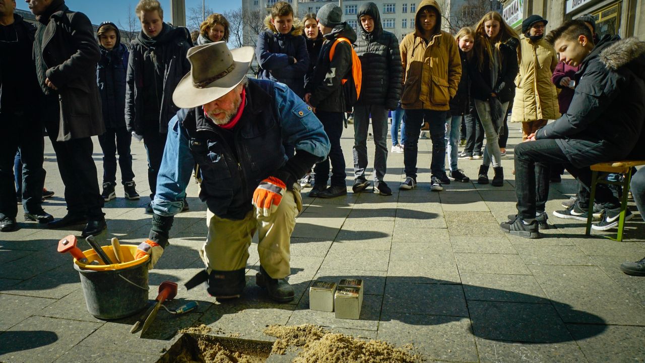 Gunter Demnig, the artist behind the "stumbling stones," installs brass plaques for individuals killed in the Holocaust.