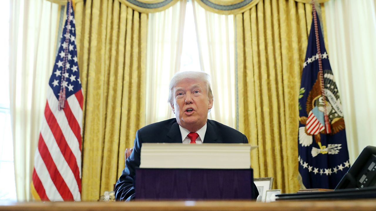 WASHINGTON, DC - DECEMBER 22:  U.S. President Donald Trump talks with journalists after signing tax reform legislation into law in the Oval Office December 22, 2017 in Washington, DC. Trump praised Republican leaders in Congress for all their work on the biggest tax overhaul in decades.  (Photo by Chip Somodevilla/Getty Images)