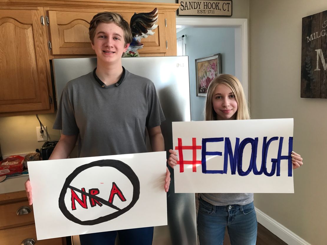 Lauren Milgram and her brother, Dalton, hold the signs they will carry in Washington.