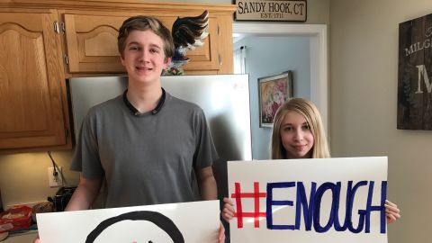 Lauren Milgram and her brother, Dalton, hold the signs they will carry in Washington.