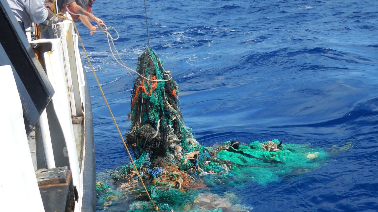 The crew pulling a ghost net from the Pacific Ocean.